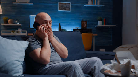 Shocked, stressed, astonished man talking at phoneの写真素材