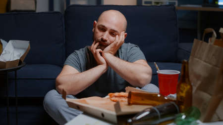 Close up of traumatized man going through a break up feeling frustration pain disappointment depression looking lost having tragic experience suffering from anxiety, chronic disease, mental problemの写真素材