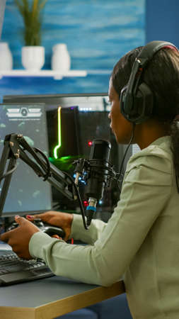 Sad african e sports streaming after losing online competition covering face wearing headphones...