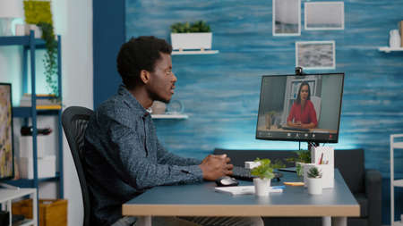 Remote worker working from home, talking on online conference internet video call with woman...