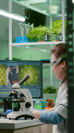 Biochemistry doctor examining chemical test using microscope for genetic researcher. Biologist...