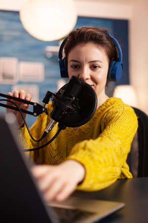 Blogger speaking with followers on live podcast using headphones. Creative online show On-air production internet broadcast host streaming live content, recording digital social media communication.の写真素材
