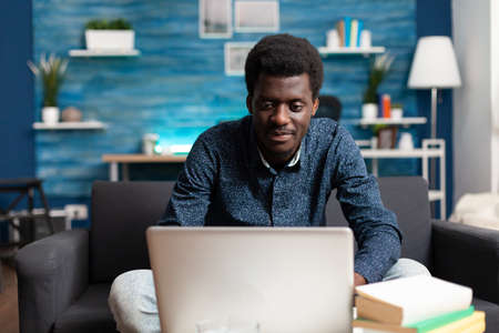 African american worker on video call conference from living room, talking on online internet...