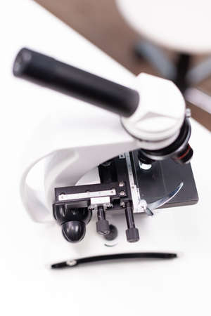 Medical microscope standing on table ready microbiology experiment in biochemistry pharmaceutical...