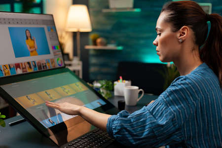 Professional editor doing retouching work on image for design project at office. Graphic artist...