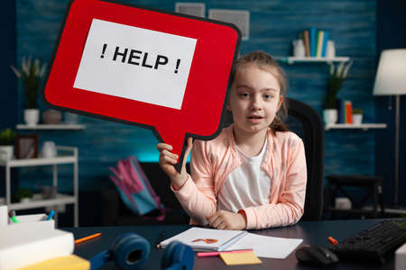 Conceptual image of little school girl needing help with homework overload burden feeling sad. Small...