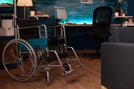 Empty living room with wheelchair and walking tools for elderly people support. Nobody at home designer for invalidity old person with medical accessibility transportation equipmentの写真素材