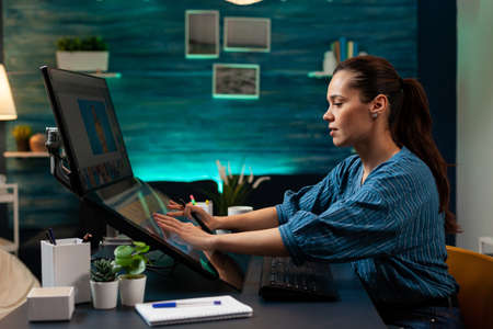 Photography designer working on image with stylus and touch interface to edit at studio agency. Woman with modern creativity equipment using monitor computer app professional technologyの写真素材