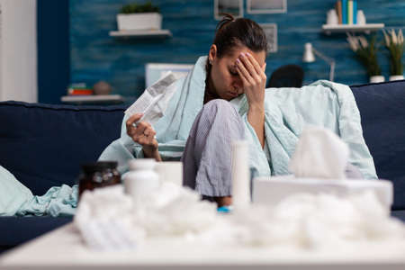 Adult woman holding prescription medicine from pharmacy doctor to cure headache illness disease. Sick person taking treatment drugs pills capsules medicament painkiller against painの写真素材