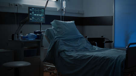 Modern hospital ward with comfortable empty bed used for medical treatment. Nobody in facility room with clinical equipment, monitor, computer, wheelchair, medicine, healing technologyの写真素材