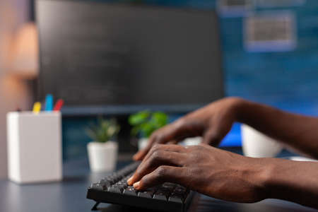 Closeup of african american employee hand programming binary code using network security system working remote from home. Programmer man browsing business server on computer. Security softwareの写真素材