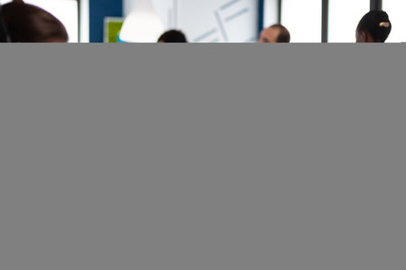 Retoucher woman editor working on computer with two monitors and stylus pencil in photo editing software sitting in creative agency office. Graphic designer retouching client photos using image appの写真素材