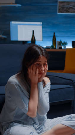 Depressed, disappointed, frustrated, ill woman holding head in hands, feeling stressed, desperate having mental problems, needs psychological help, addicted heartbroken experiencing loneliness crisisの写真素材