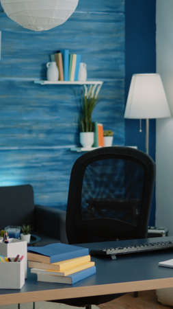 Little girl sitting at desk using computer and keyboard for school work at home. Concentrated pupil with homework looking at monitor on internet connection for remote online lessons.の写真素材