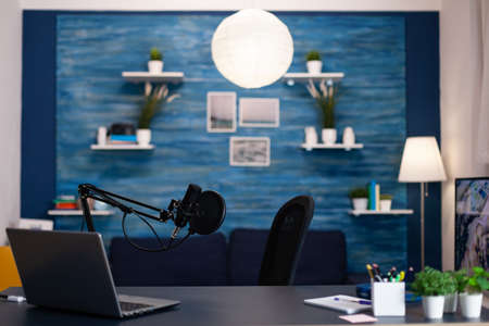 Empty podcast studio with nobody in it equipped with professional production podcasting equipment ready for entertainment vlog. Digital web internet streaming station. On-air show in living roomの写真素材