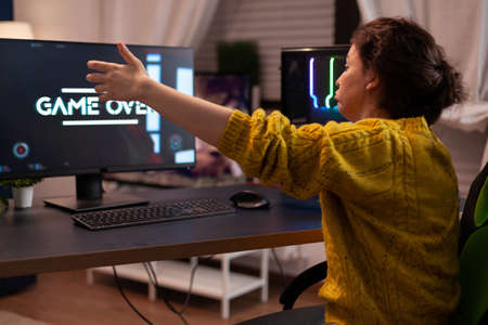 Angry competitive losing space shooter videogames during online entertainment championship at home...