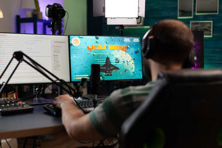 Player winning gameplay with live chat on stream. Man streaming and playing video games, celebrating...