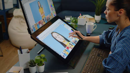 Close up of retouching software on touch screen at studio. Photographer working on editing app for pictures design. Image editor doing retouch work on photo using graphic tablet.の写真素材