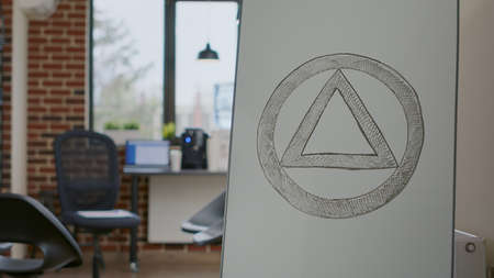 Close up of anonymous alcoholics sign on white board in office used for group therapy program. Concept of AA meeting symbol to cure alcohol addiction and mental health problems.の写真素材