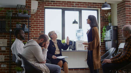 Angry woman explaining anger management problems at aa group meeting with psychiatrist. Desperate...