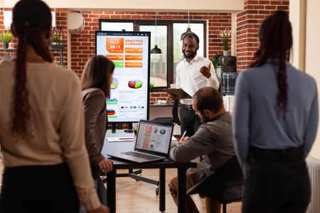 Business team working at marketing project analyzing company graph brainstorming business ideas in...