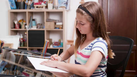 Children painter drawing creative sketch on paper using graphic pencil working at elementary...