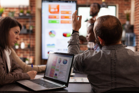Businesspeople working at management project analyzing company graph brainstorming business ideas in...