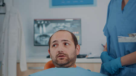 Patient with caries problems receiving consultation from dentistry team. Stomatological experts...
