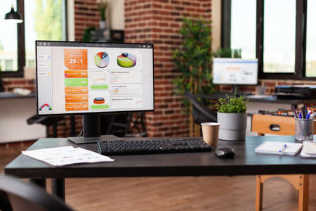 Empty business office with computer and instruments on desk. Close up of monitor with financial...
