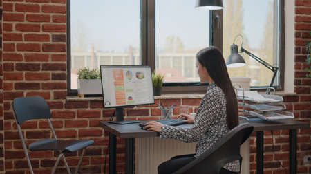 Person using computer to design business charts and plan project. Woman working with marketing strategy to help with company growth and development in startup office. Employee at jobの写真素材