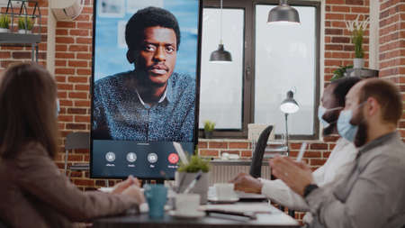 Business people talking to man on online video call conference, using remote telecommunication on...