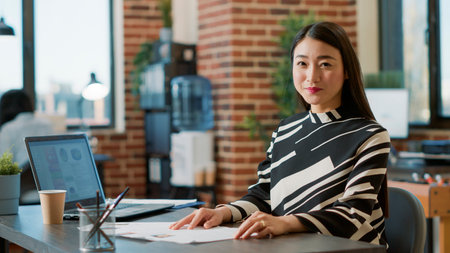Portrait of female worker using recruitment papers to start job interview with candidates, finding person to hire for executive business work. HR employee looking at cv for career experience.の写真素材