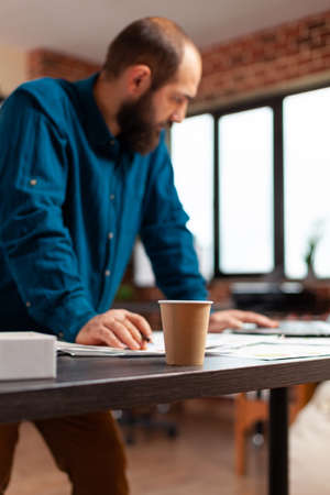Businessman analyzing company statistics on laptop computer checking marketing strategy working at...