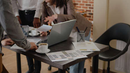 Close up of diverse group planning business project and strategy in startup office. People doing...
