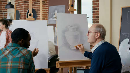 Diverse team of men attending art class lesson together to develop new artistic skills. Creative...