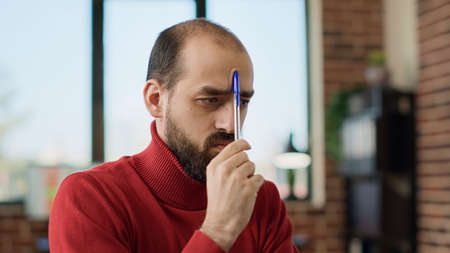 Puzzled male employee brainstorming ideas about business growth, thinking about financial decision...