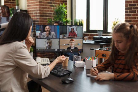Business woman on virtual conference videocall communicating marketing strategy to company partners. Financial agency employees brainstorming client oriented project ideas while in digital meeting.の写真素材