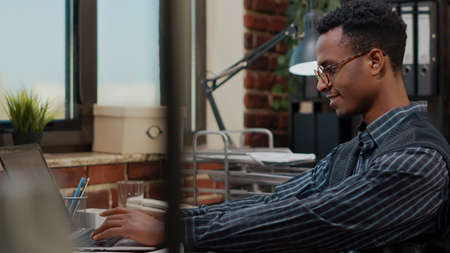 Company employee looking at laptop screen to plan career success, working on business development...