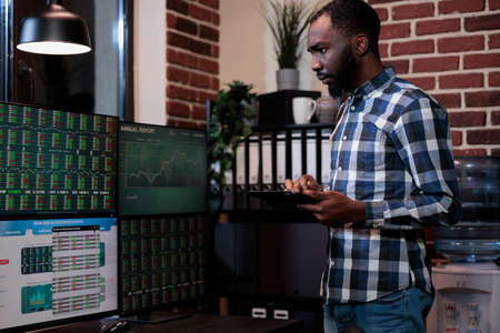 Business company professional investor having touchscreen tablet while analyzing market trend to...