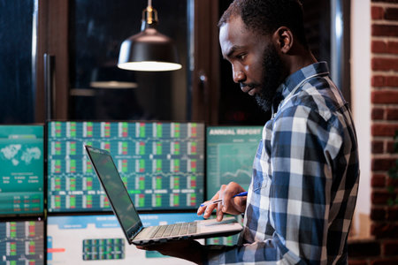 Forex trading agency agent with laptop predicting market trend using financial analysis and capital...