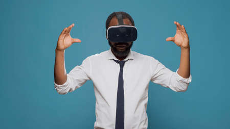 Male freelancer using vr glasses with futuristic vision in studio, working on innovative simulator....