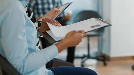 Female candidate sitting in queue and receiving cv files, waiting to start job interview about...