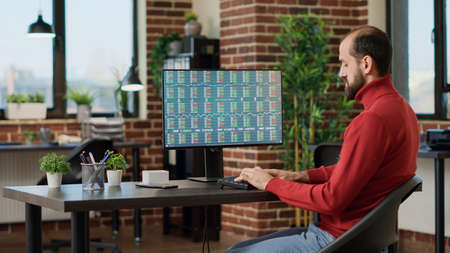 Hedge fund trader analyzing real time forex information to create trading investment and profit...