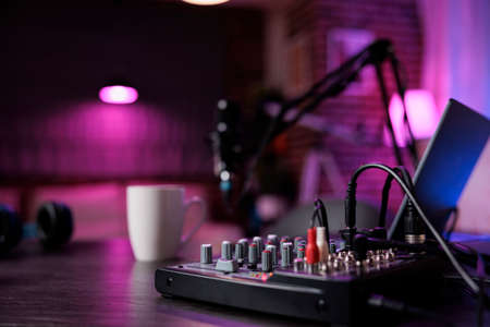 No people at empty desk with podcast equipment in living room, recording sound for social media...