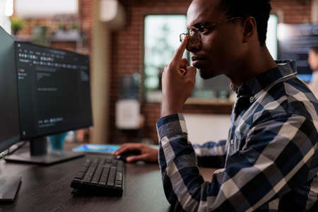 Thoughtful blockchain developer reflecting at low levels of security and how to improve mainframe...