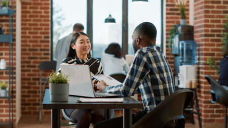 African american recruiter greeting asian woman at job interview, meeting to discuss about...