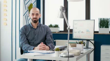 Executive assistant doing data research on computer with sales report and company statistics. Project leader working with financial data to plan marketing development. Handheld shot.の写真素材