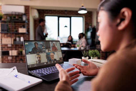 Businesswoman calling people on online teleconference, having remote conversation on video call...