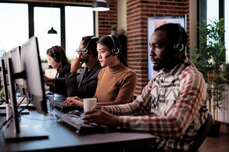 Sales assistant answering helpline call from client at helpdesk, working at customer care support...