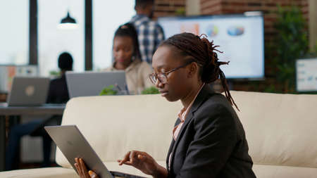 Business woman brainstorming ideas to work on strategy, using laptop computer to plan financial...